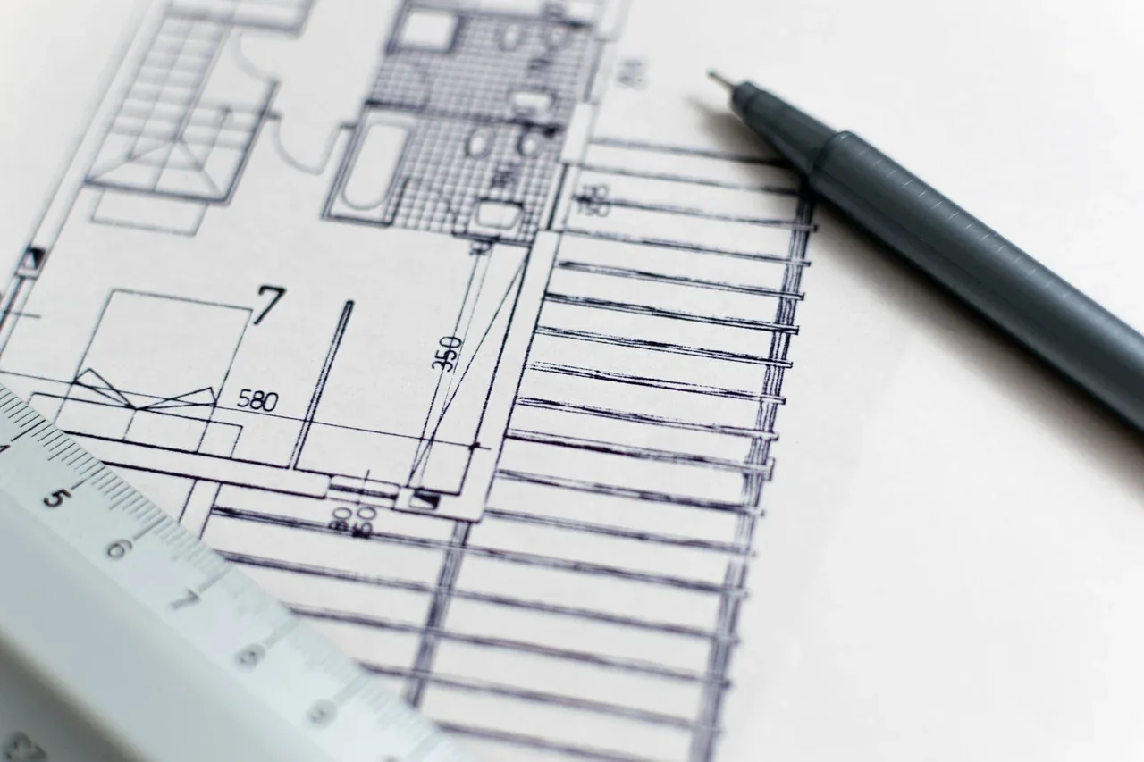 A construction drawing with a pen resting on it
